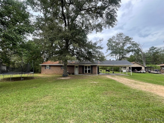 view of front of house with a front lawn and a trampoline