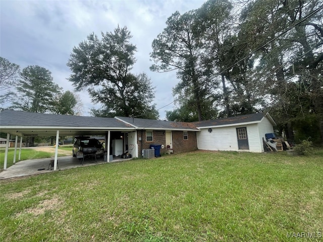 rear view of house featuring a yard and a patio area