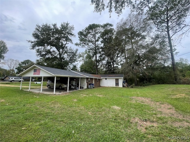 rear view of house featuring a carport and a lawn