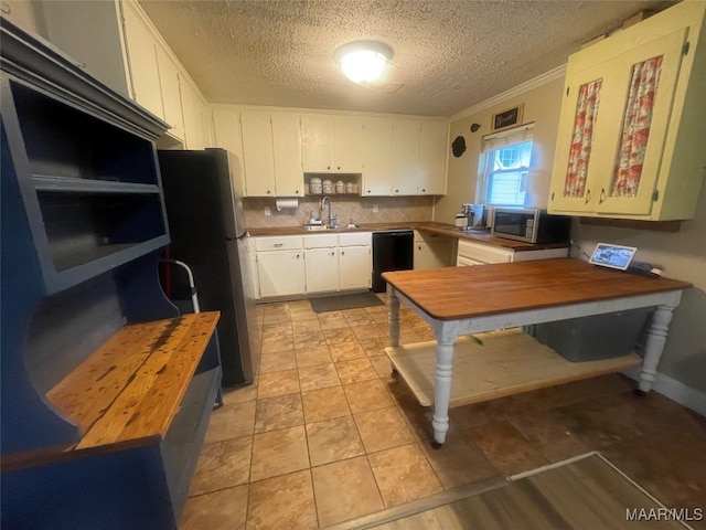 kitchen featuring sink, wooden counters, white cabinetry, stainless steel appliances, and crown molding