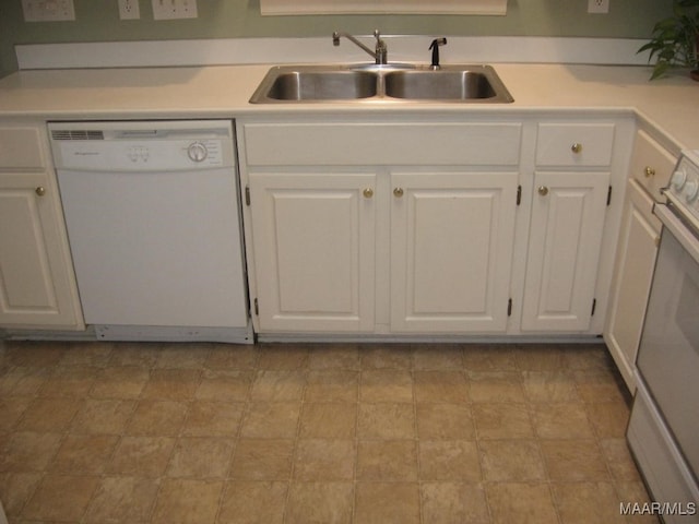 kitchen with sink, white appliances, and white cabinetry