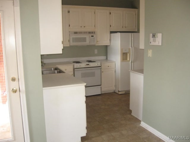 kitchen featuring white cabinets, sink, and white appliances