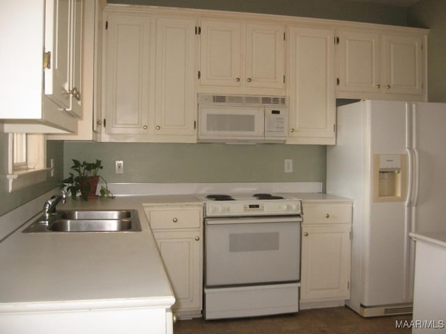 kitchen featuring white cabinets, sink, and white appliances