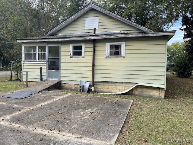 view of side of property with a lawn