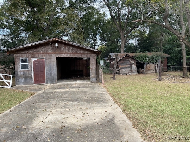 view of outbuilding with a yard and a garage