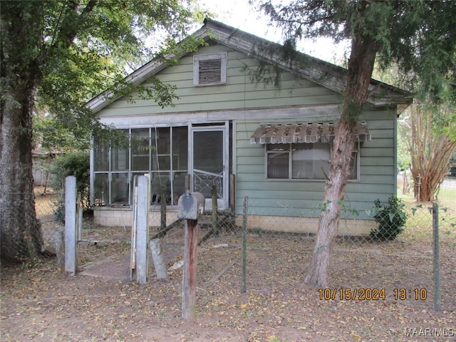 view of home's exterior with a sunroom