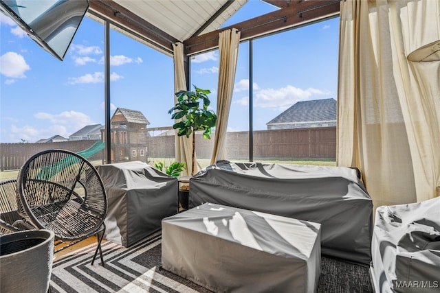 sunroom / solarium featuring vaulted ceiling