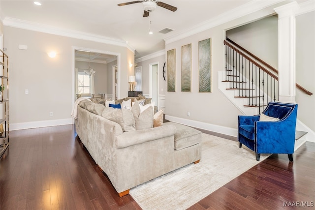 living room featuring ceiling fan with notable chandelier, ornamental molding, and dark hardwood / wood-style flooring