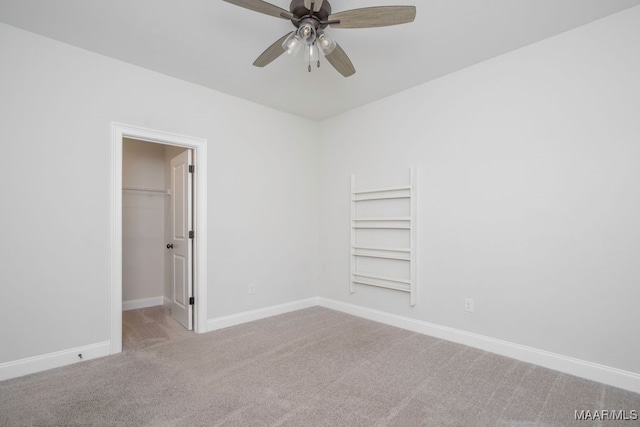 empty room with carpet flooring and ceiling fan