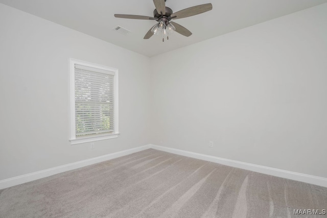 carpeted empty room featuring ceiling fan