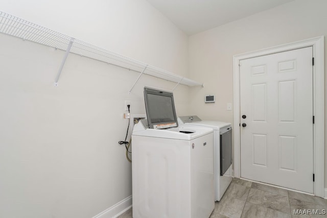 clothes washing area with washer and clothes dryer