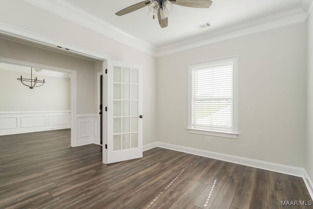 empty room featuring french doors, dark hardwood / wood-style floors, ornamental molding, and ceiling fan