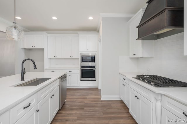 kitchen with custom exhaust hood, hanging light fixtures, sink, white cabinetry, and dark hardwood / wood-style floors