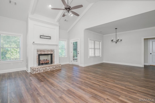 unfurnished living room featuring a brick fireplace, ceiling fan with notable chandelier, crown molding, dark hardwood / wood-style flooring, and high vaulted ceiling