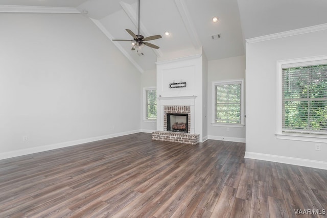 unfurnished living room featuring a brick fireplace, high vaulted ceiling, plenty of natural light, and dark hardwood / wood-style floors