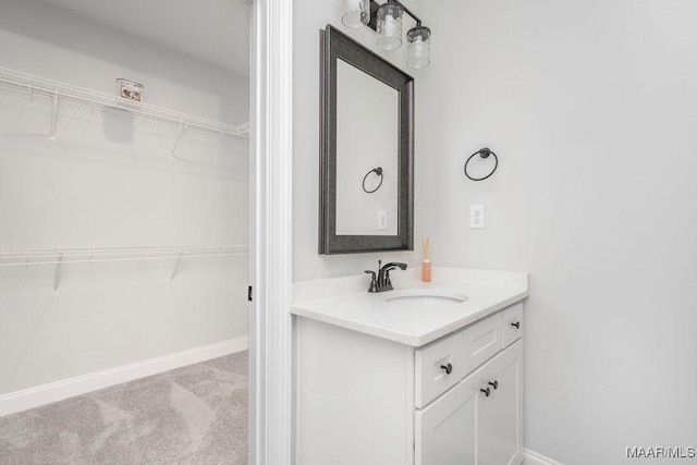 78 Hillston Dr, Wetumpka, AL 36093 - bathroom featuring a walk in closet, vanity, and baseboards