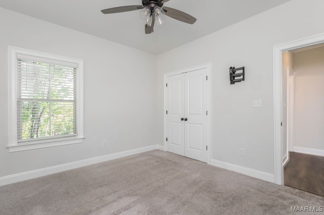 unfurnished bedroom with ceiling fan, carpet floors, and a closet