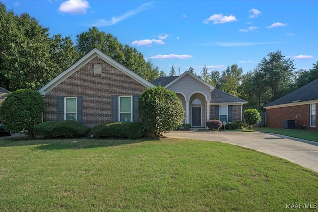 single story home with central air condition unit and a front yard