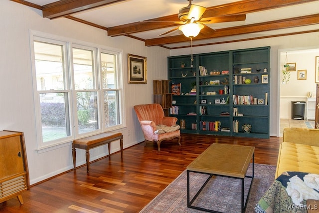 sitting room featuring ceiling fan, beam ceiling, ornamental molding, and dark hardwood / wood-style flooring