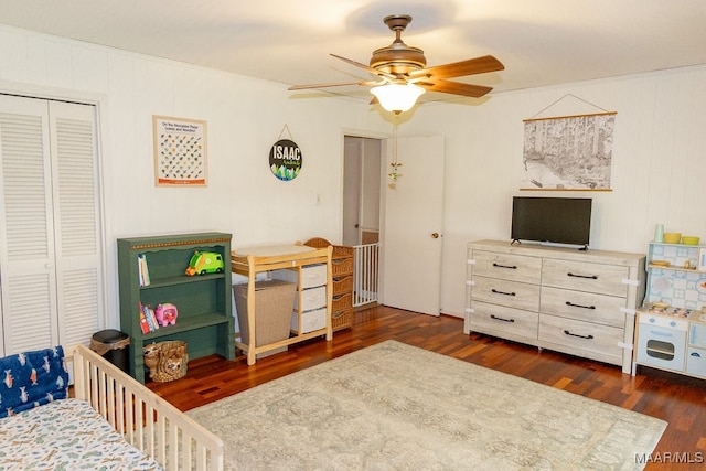 bedroom featuring ceiling fan, a closet, and dark wood-type flooring