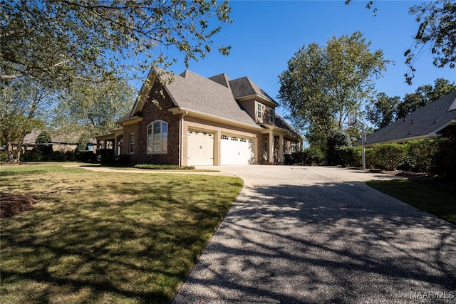 view of side of home featuring a lawn and a garage