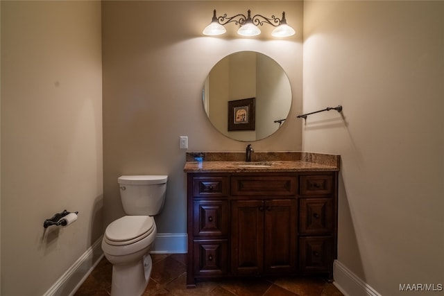 bathroom with vanity, toilet, and tile patterned flooring