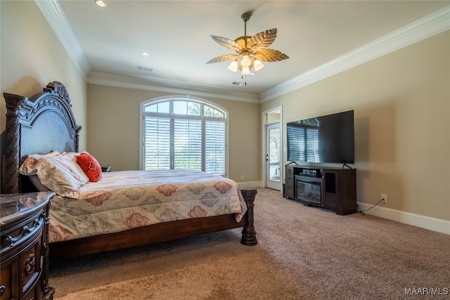 bedroom with ceiling fan, ornamental molding, and carpet floors