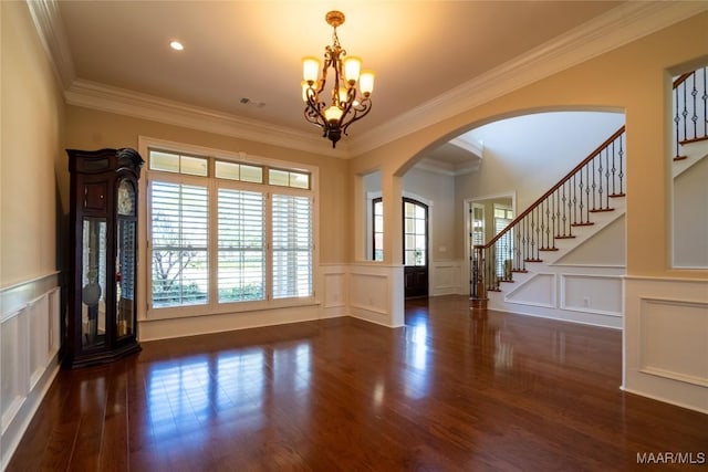 156 Walnut Point Dr, Wetumpka, AL 36093 - interior space with arched walkways, a notable chandelier, ornamental molding, and a decorative wall