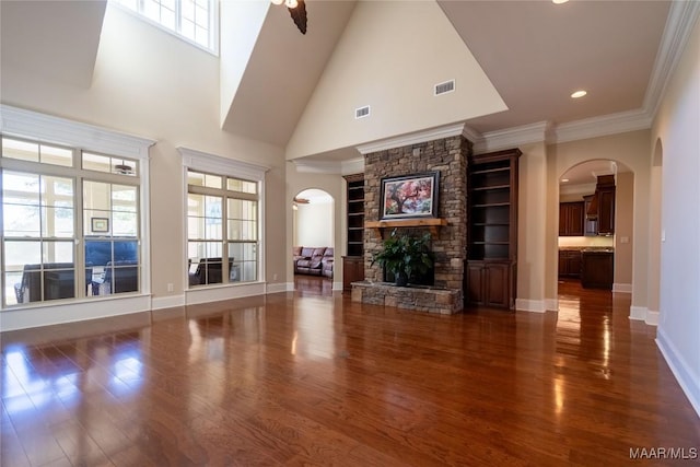 156 Walnut Point Dr, Wetumpka, AL 36093 - unfurnished living room with baseboards, visible vents, arched walkways, and wood finished floors
