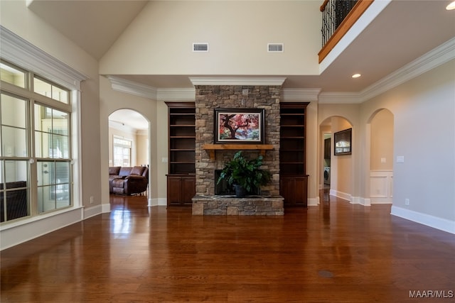 unfurnished living room featuring ornamental molding, dark wood-type flooring, and a fireplace