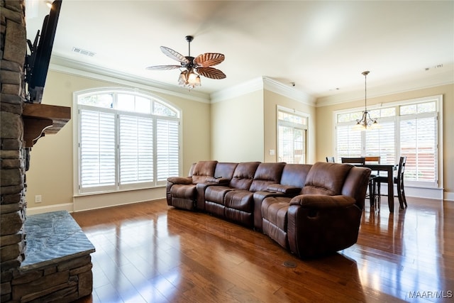 living room featuring crown molding, a healthy amount of sunlight, and dark wood-type flooring