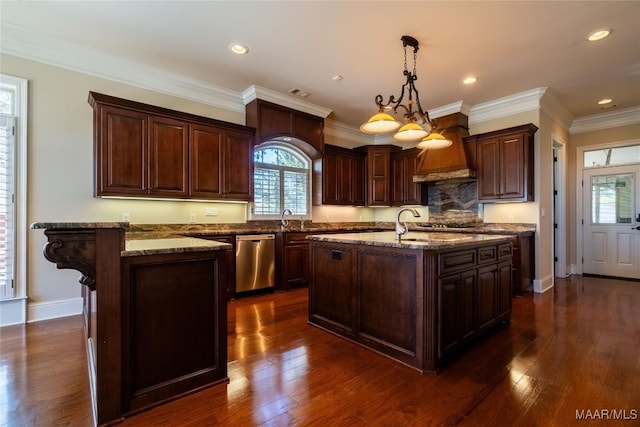 156 Walnut Point Dr, Wetumpka, AL 36093 - kitchen with stainless steel dishwasher, custom exhaust hood, light stone counters, decorative light fixtures, and a peninsula