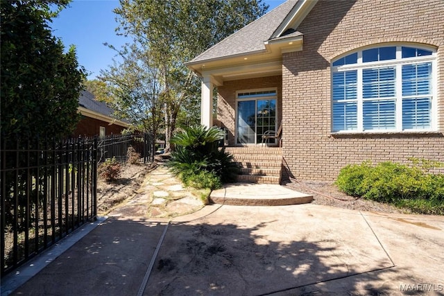 156 Walnut Point Dr, Wetumpka, AL 36093 - view of side of home featuring fence, roof with shingles, a patio, and brick siding