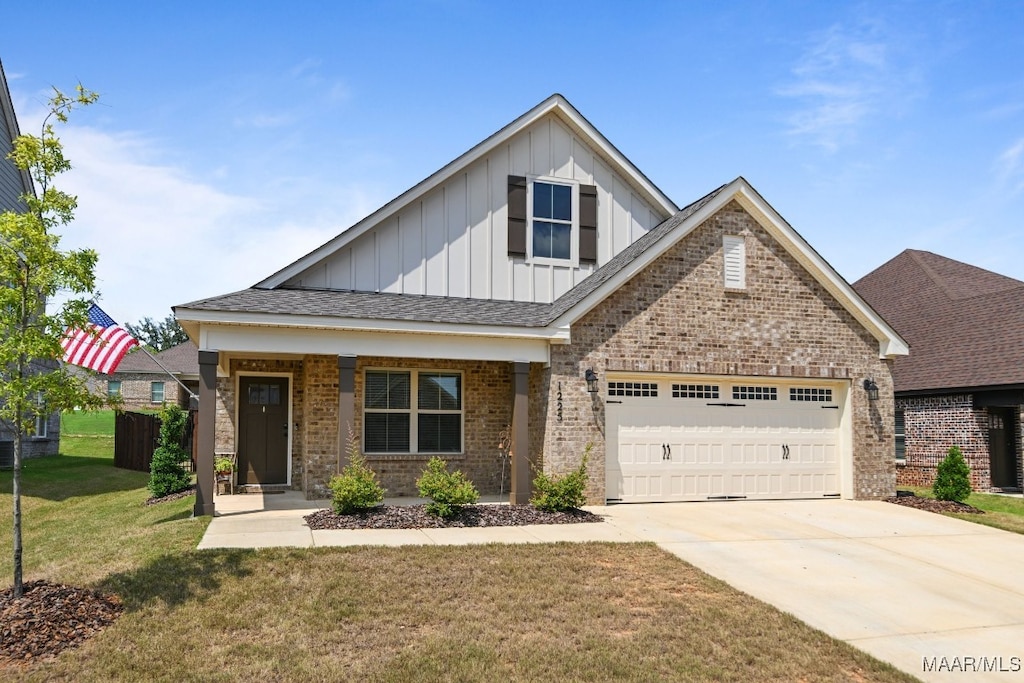 craftsman-style home featuring a front lawn, covered porch, and a garage