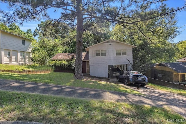 view of home's exterior with driveway and a lawn