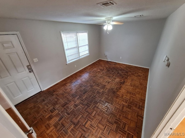 foyer entrance with visible vents, ceiling fan, and baseboards