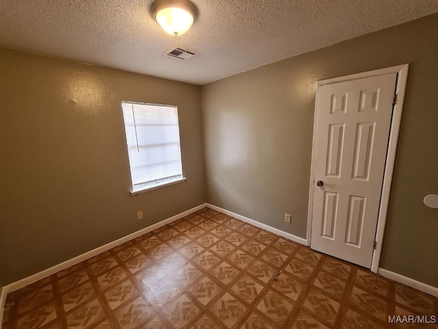 empty room with a textured ceiling