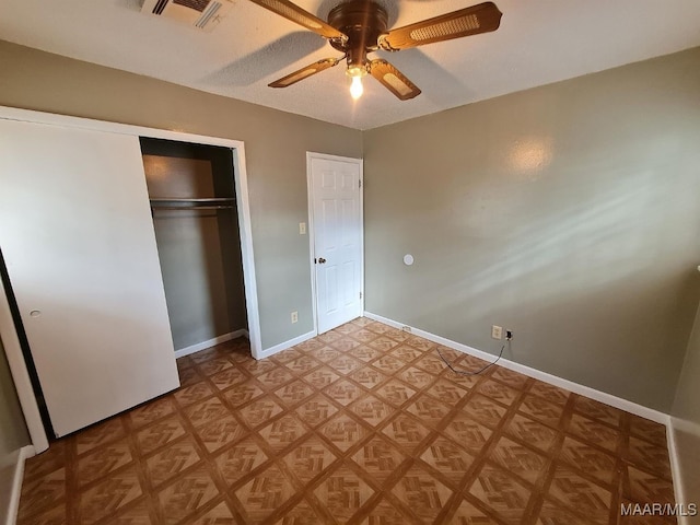 unfurnished bedroom featuring a closet and ceiling fan