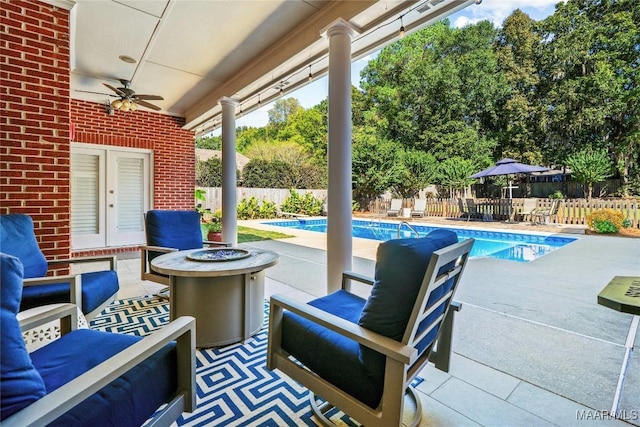 view of patio / terrace with ceiling fan, a fenced in pool, and a fenced backyard