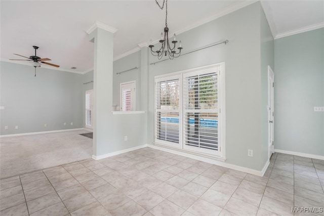 carpeted spare room with ornamental molding, baseboards, and ceiling fan with notable chandelier