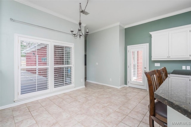 dining area featuring baseboards, plenty of natural light, ornamental molding, and a notable chandelier