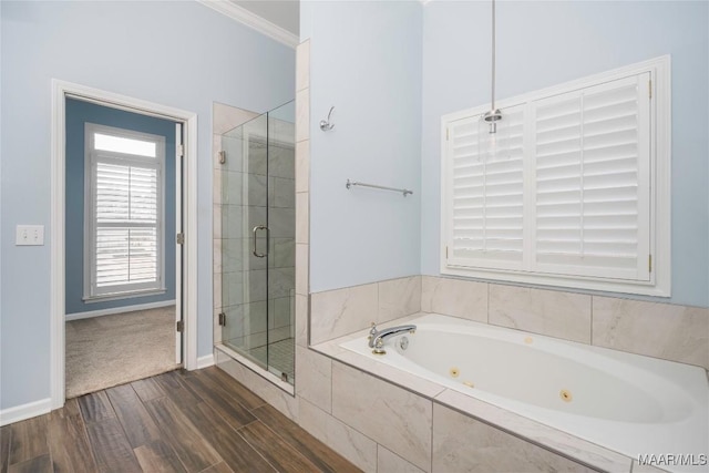 full bath featuring ornamental molding, a stall shower, wood finished floors, baseboards, and a tub with jets