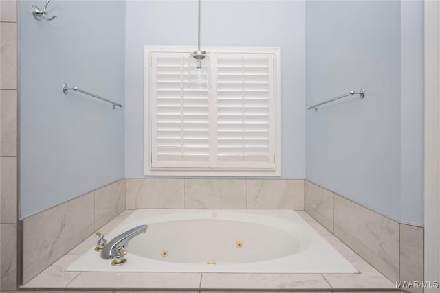 bathroom featuring a tub with jets