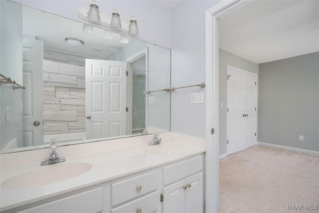 full bath with a sink, baseboards, and double vanity