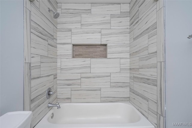 bathroom featuring washtub / shower combination and toilet