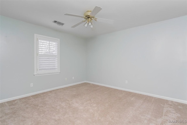 unfurnished room with light carpet, ceiling fan, visible vents, and baseboards