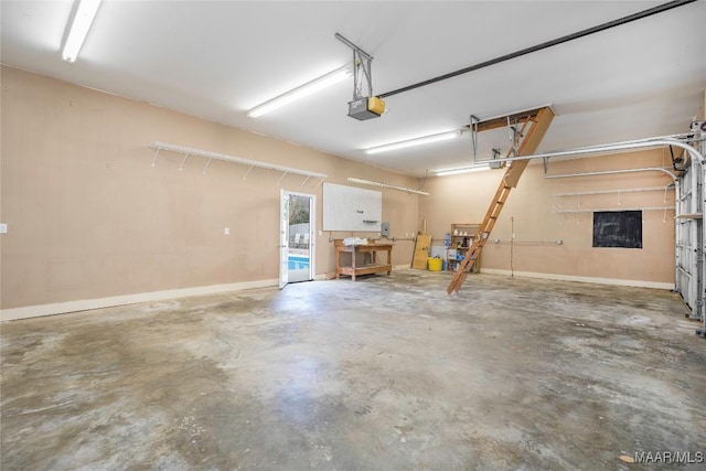 garage with baseboards and a garage door opener