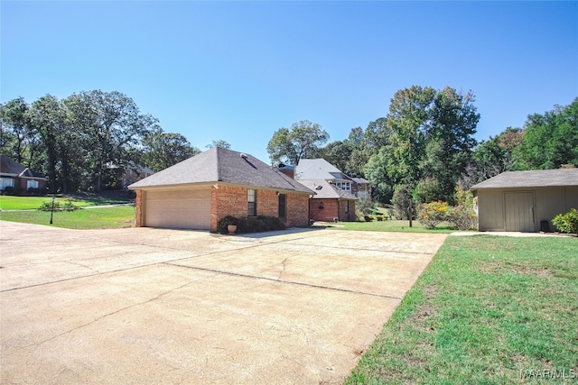 view of side of home featuring a lawn and a garage