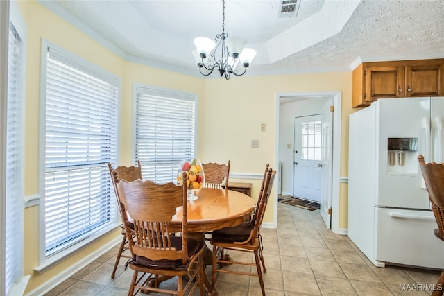 dining space featuring a notable chandelier, a textured ceiling, plenty of natural light, and light tile patterned floors