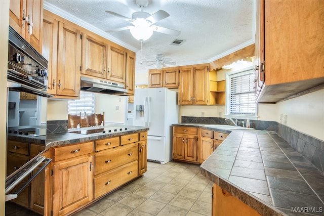 kitchen with crown molding, a healthy amount of sunlight, and white refrigerator with ice dispenser